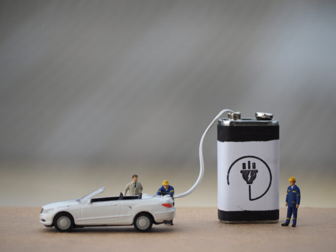miniature car being recharged by a large battery